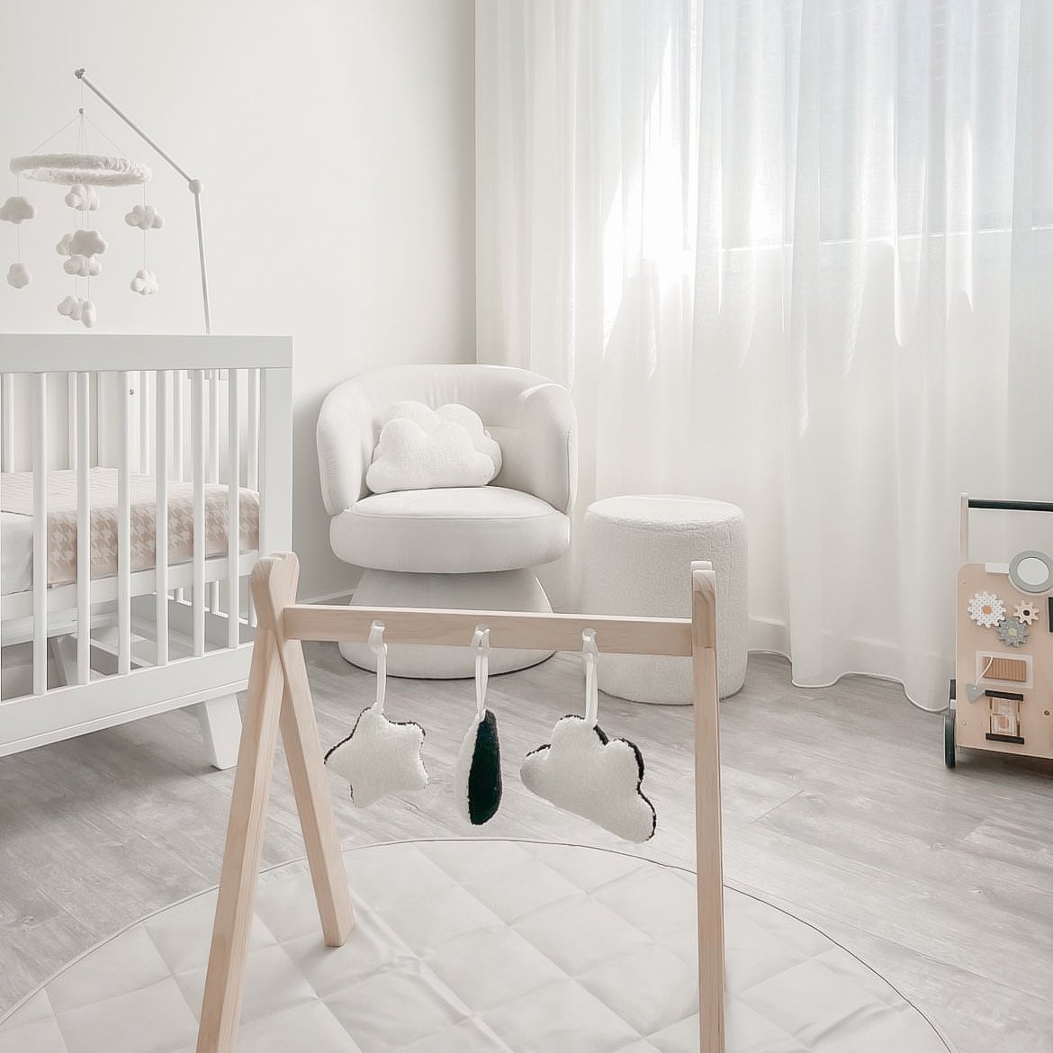 High contrast black and white baby accessories for play gyms in clouds, moons or star charms. Styled in aesthetic nursery.