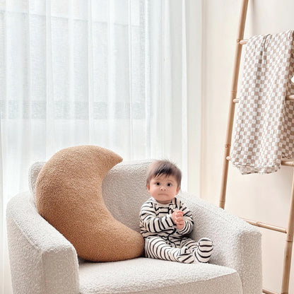 Cosy Mum feeding her baby in nursing chair with our Moon Support Cushion (for bottle feeding or breastfeeding). Caramel colour featured with happy baby.