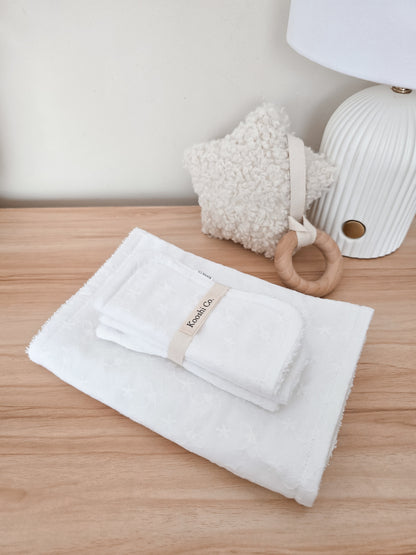 Handmade high quality burp cloths and face and body washers designed to be practical and aesthetic. White floral embroidery design.